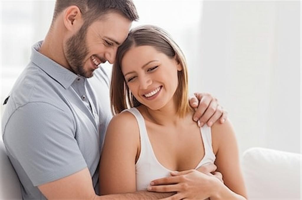 Happy couple smiling and hugging after intimacy